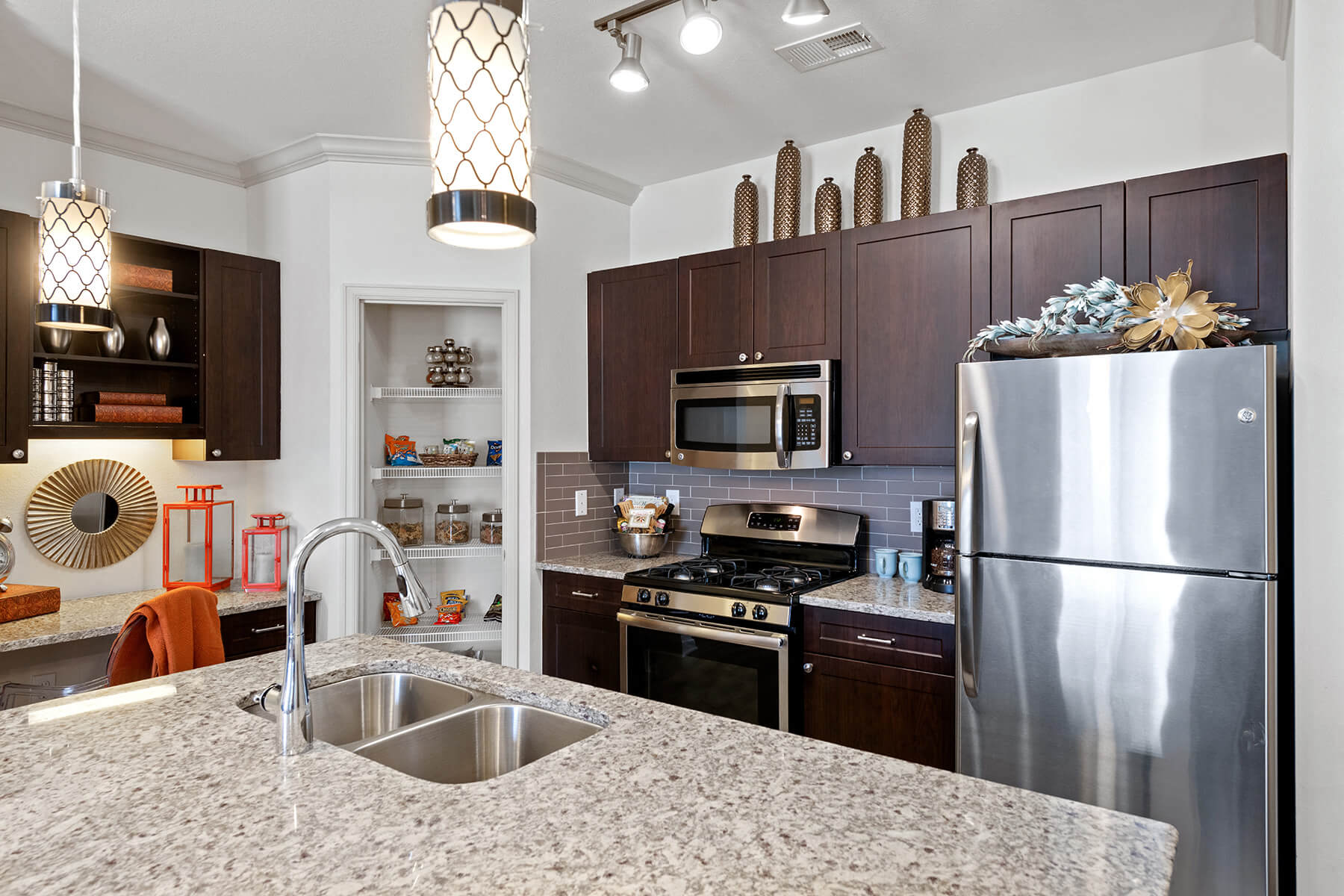 A modern kitchen with a kitchen island at the Atley on the Greenway apartments in Ashburn, Virginia.